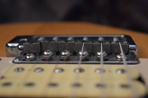 Guitar nut height adjustment – The easy way. Height compensation at the bridge.
