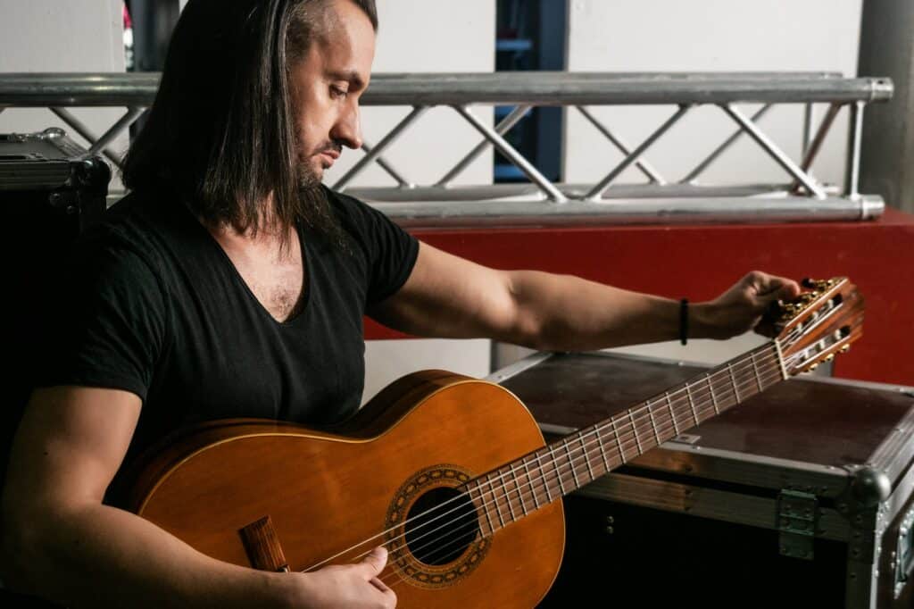 a man tuning a guitar