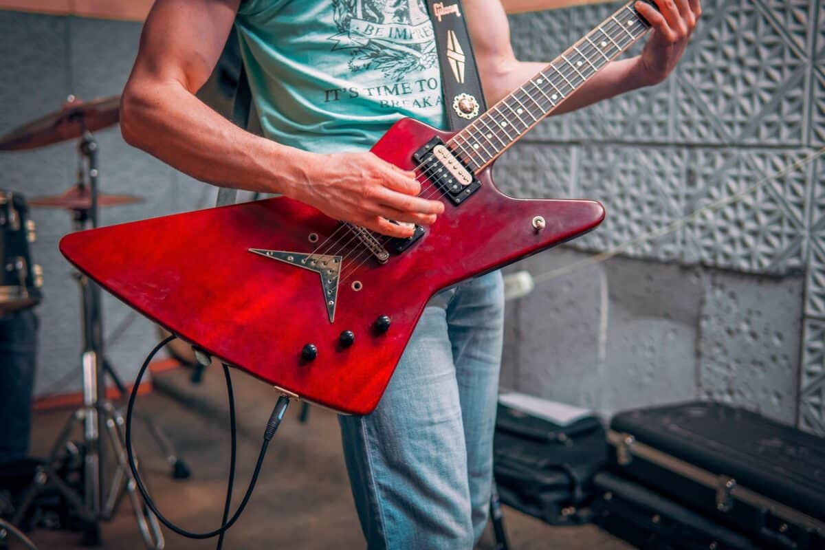 man playing electric guitar in studio