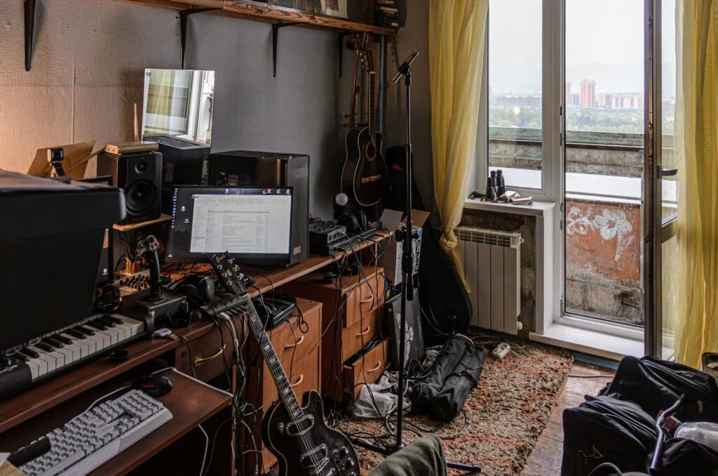 Photo by Radik 2707: https://www.pexels.com/photo/a-room-with-a-desk-keyboard-guitar-and-other-musical-equipment-27348308/